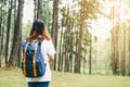 Traveler asian woman with backpack walking on path in the tropical forest. Adventure wanderlust travel people concept. Royalty Free Stock Photo