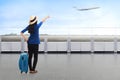 Traveler asian woman carrying suitcase looking airplane