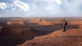 Traveler on the background of rocky formations in the Dasht e Lut desert. Nature of Iran. Persia.