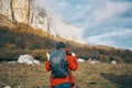 traveler with backpack in autumn in the mountains blue sky clouds high rocks landscape Royalty Free Stock Photo