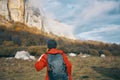 traveler with backpack in autumn in the mountains blue sky clouds high rocks landscape Royalty Free Stock Photo