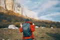 traveler with backpack in autumn in the mountains blue sky clouds high rocks landscape Royalty Free Stock Photo