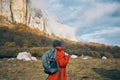 traveler with backpack in autumn in the mountains blue sky clouds high rocks landscape Royalty Free Stock Photo