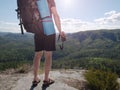 Traveler with backpack and camera in hands exploring nature