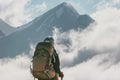 Traveler with backpack enjoying mountains clouds landscape Royalty Free Stock Photo