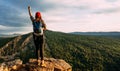 A traveler with a backpack in the mountains at sunset. A traveler with a backpack on the background of mountains, rear view.