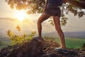 A traveler with a backpack standing on top of a mountain Royalty Free Stock Photo