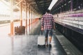 Traveler with baggage and map in train station. Travel concept