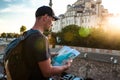 A traveler in a baseball cap with a backpack is looking at the map next to the blue mosque - the famous sight of Royalty Free Stock Photo