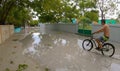 Traveler on bike explores a small village in Maldives after torrential rain Royalty Free Stock Photo