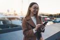 Traveler businesswoman mobile phone in evening port Barcelona. Girl tourist in glasses using online technology Royalty Free Stock Photo