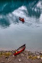 Traveler canoeing with red canoe parked on Maligne lake Royalty Free Stock Photo