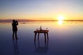 Traveler Celebrating on the Flooding Salt Flats, the Iconic Mirror Effect of Salar de Uyuni at Stunning Sunset, Bolivia
