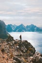 Traveler on cliff in Norway hiking solo Travel adventure active vacations outdoor healthy lifestyle