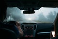 A traveler couple in the car on the way home in fog. Back view Royalty Free Stock Photo