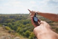 Traveler couple searching direction with a compass in summer mountains. Searching the way on canyon. Royalty Free Stock Photo