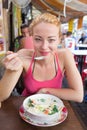 Traveler eating traditional thai Tom Yum soup.