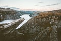 Traveler on the edge of Trolltunga cliff traveling in Norway Royalty Free Stock Photo