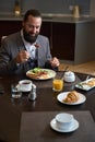 Traveler enjoys the comfort of having breakfast at the hotel