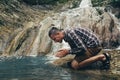 Traveler Explorer Sits By River And Prays Faith Religious Harmony With Nature Concept