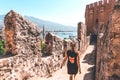 Traveler exploring the city of Alanya in Turkey. Woman walking and discovering old landmark in Europe.