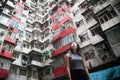 Traveler Exploring Densely Populated Housing Apartments in Hong Kong