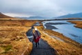 Traveler at famous Kirkjufellsfoss waterfall in Iceland