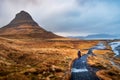 Traveler at famous Kirkjufellsfoss waterfall in Iceland