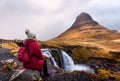 Traveler at famous Kirkjufellsfoss waterfall in Iceland