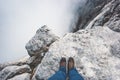 Traveler Feet boots on rocky mountain cliff