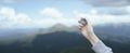 Traveler hand holds a compass in the mountains. Horizontal banner with place for text Royalty Free Stock Photo