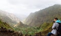 Traveler in front of motion landscape. Deep clouds above green Xo-Xo Valley. Santo Antao Island, Cape Verde