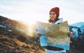 Traveler girl look and hold in hands map, people planning trip, hipster tourist on background sun flare nature, enjoy journey