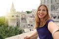 Traveler girl taking selfie on sunset in Budapest, Hungary. Young tourist woman takes self portrait on Fisherman`s Bastion in the Royalty Free Stock Photo