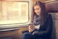 Traveler girl use the phone on train Royalty Free Stock Photo