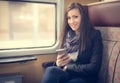 Traveler girl use the phone on train Royalty Free Stock Photo