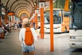 Traveler girl is waiting for a bus at the bus station. Trip to E Royalty Free Stock Photo