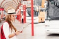 Traveler girl is waiting for a bus at the bus station. Trip to E Royalty Free Stock Photo