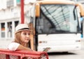 Traveler girl is waiting for a bus at the bus station. Trip to E Royalty Free Stock Photo