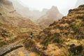 Traveler on great walking destination with stunning views of rugged coast lines and narrow canyons. Santo Antao Cape