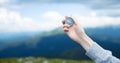 Traveler hand holds compass against beautiful Carpathian mountains view. Horizontal banner with place for text. Royalty Free Stock Photo