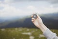 Traveler hand holds a compass on the beautiful Carpathian mountains during vacation. Horizontal banner with place for Royalty Free Stock Photo