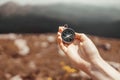 Traveler hand holds a compass on the beautiful Carpathian mountains view in a sun. Horizontal banner with place for text Royalty Free Stock Photo