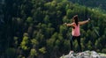 The traveler is happy to climb the mountain, panorama. A girl meets the sunset in the mountains. Mountain sports. Royalty Free Stock Photo