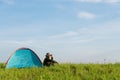 Traveler having camping with tent on grass field