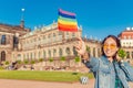 Traveler having fun in Dresden with rainbow flag symbol. Free love relationship concept