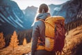 Traveler hiker camper woman wearing Big Trekking Backpack. Viewed from the back. Mountains landscape. Hiking, trekking