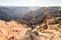 Traveler hiker feet sitting on the edge of a cliff in Grand Canyon West Rim, Arizona, USA Royalty Free Stock Photo