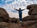 Traveler hiker man with backpack raised hands mountain summit. Active Lifestyle tourism Solo Travel Scenic hiking trail Royalty Free Stock Photo