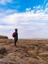 Traveler hiker woman with backpack raincoat walking on mountain summit. Girl backpacker enjoying scenic landscape hiking Royalty Free Stock Photo